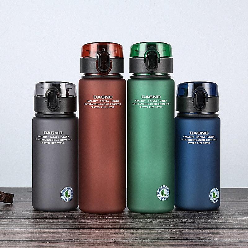 Four colorful water bottles with 'CASNO' branding on a wooden surface.