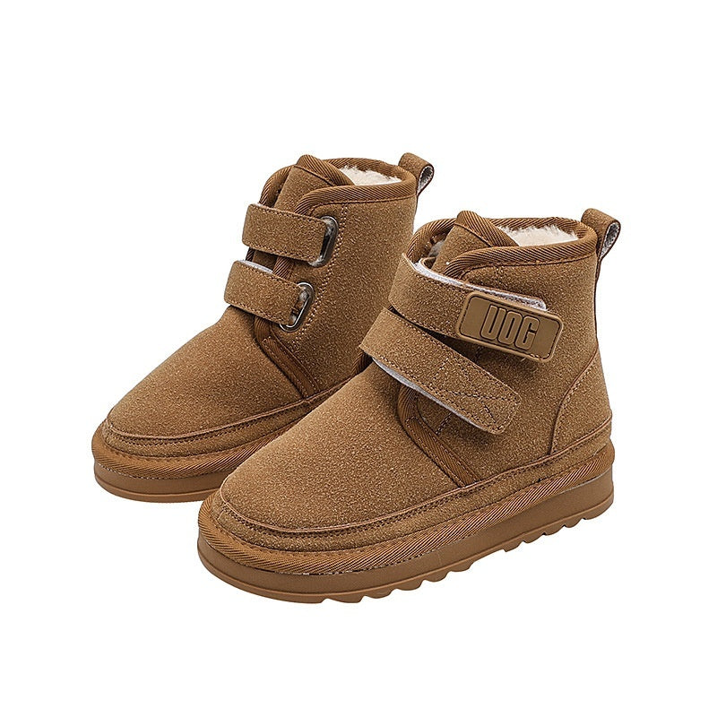 Pair of brown children's boots with velcro straps on a white background