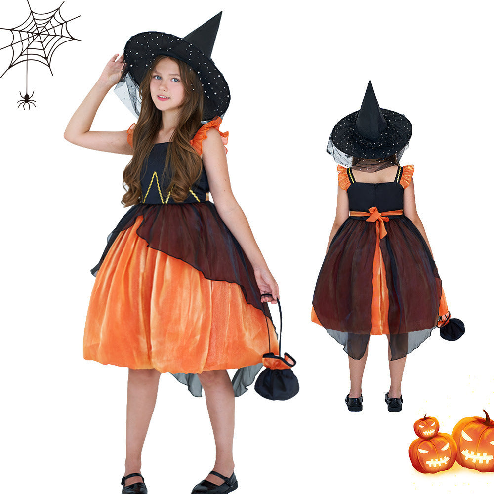A young girl modeling a Halloween witch costume dress, shown from both the front and back views against a plain white background. The costume features a black bodice with yellow embroidered details, a black pointed witch hat with a veil, and a tiered skirt in orange and dark brown.