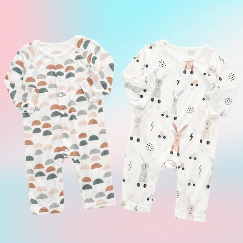 Two baby rompers with different patterns on a gradient background