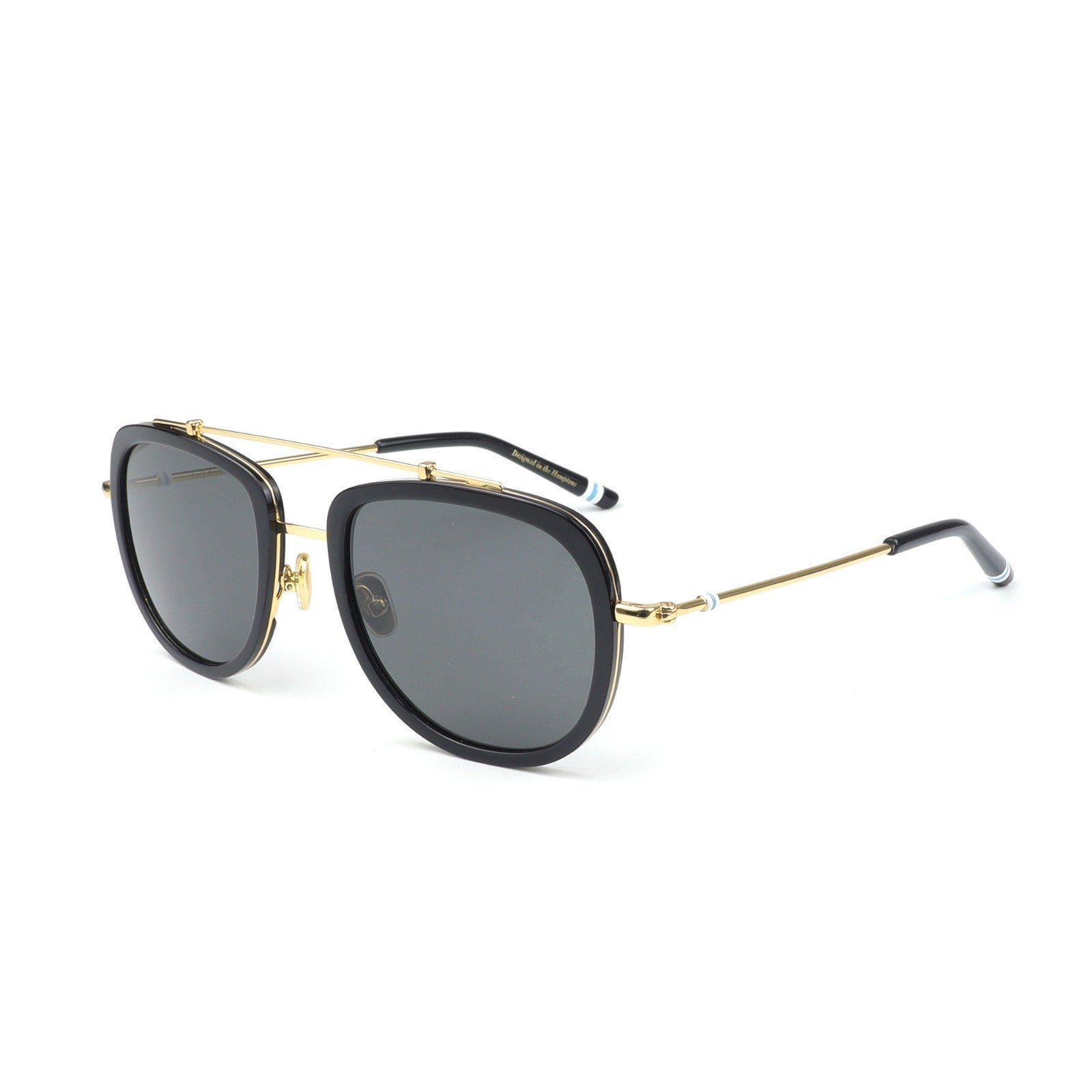 Sunglasses with black lenses and gold frames on a white background