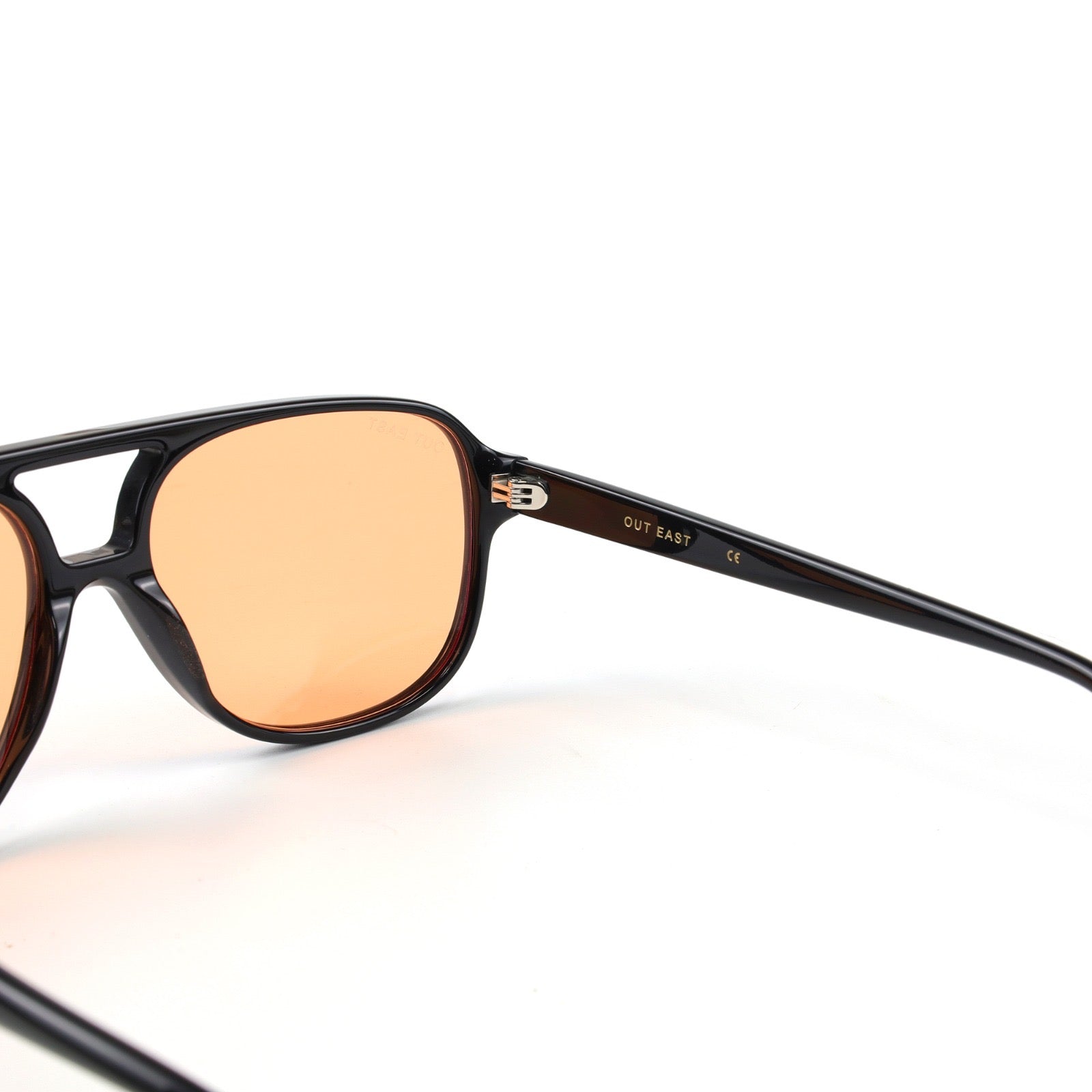 Sunglasses with brown lenses and black frame on a white background