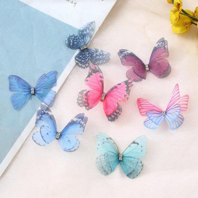 Colorful butterfly-shaped decorations on a light surface with a blue card in the background.
