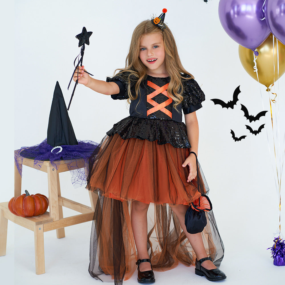 Young girl in a Halloween costume with witch hat, broom, and balloons on a white background
