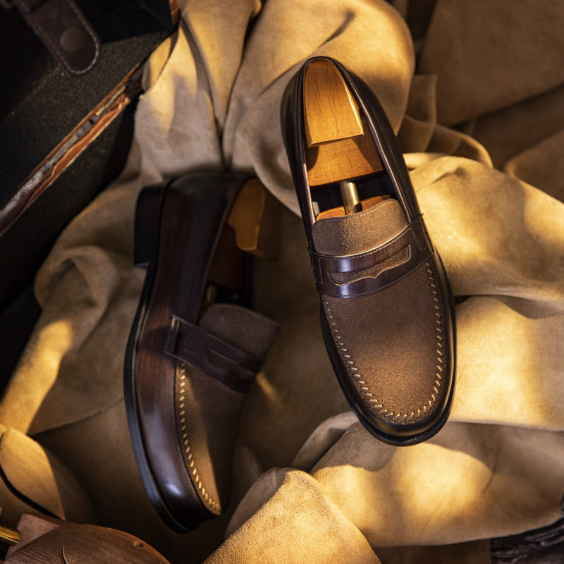 Brown leather loafers on a textured fabric background