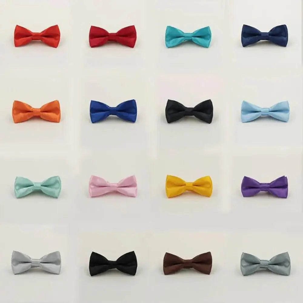 A grid of 16 small bow ties in assorted colors on a plain light background, including red, turquoise, navy, orange, blue, black, light blue, mint, pink, yellow, purple, gray, and brown.