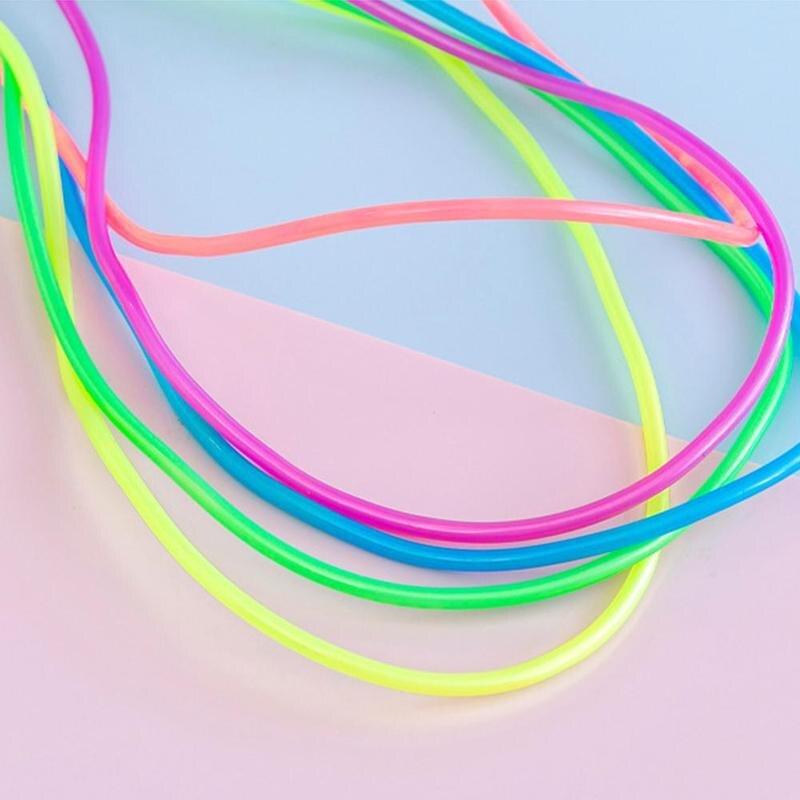 Neon jump ropes in pink, blue, green, and yellow on a light gradient background