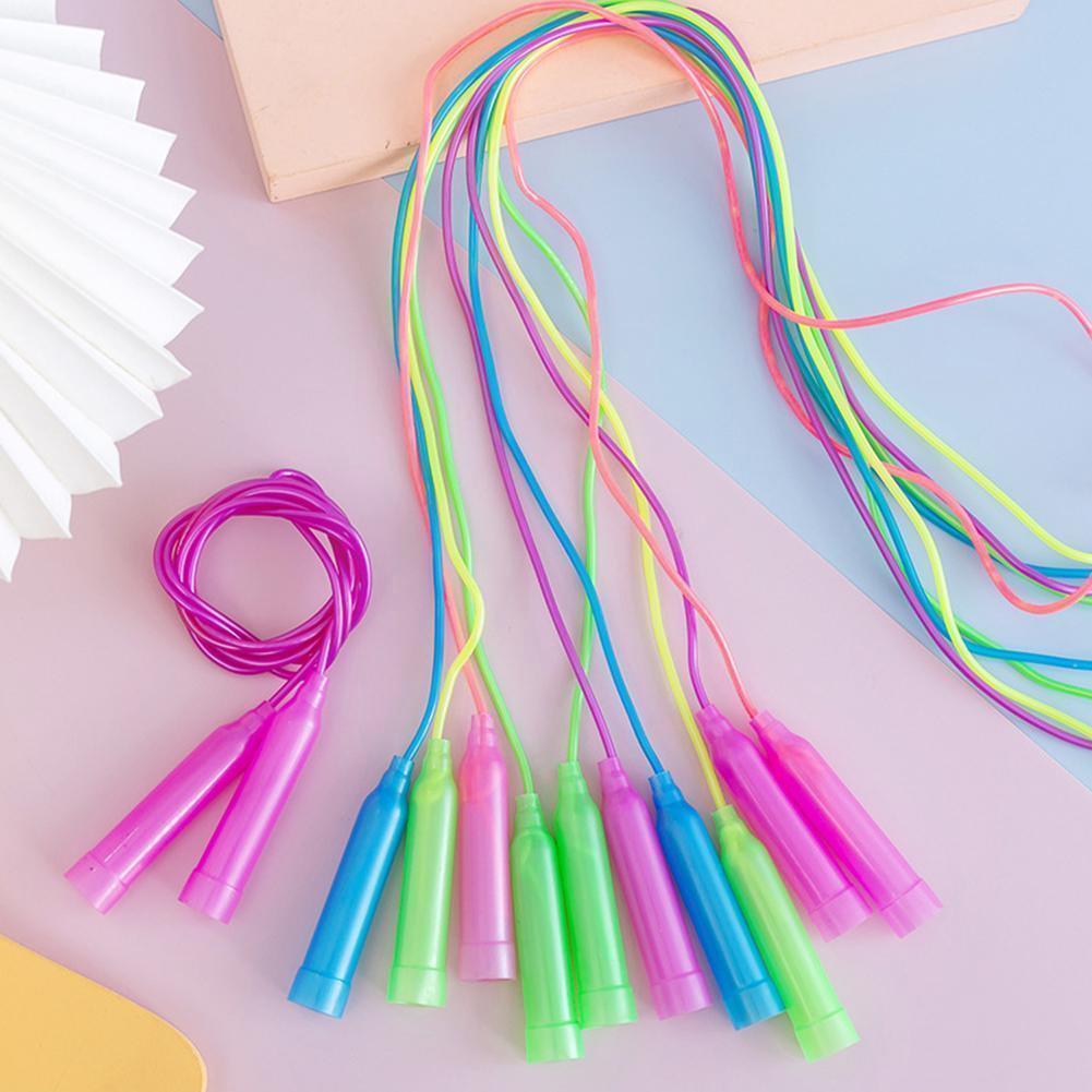 Colorful jump rope with plastic handles on a pastel background