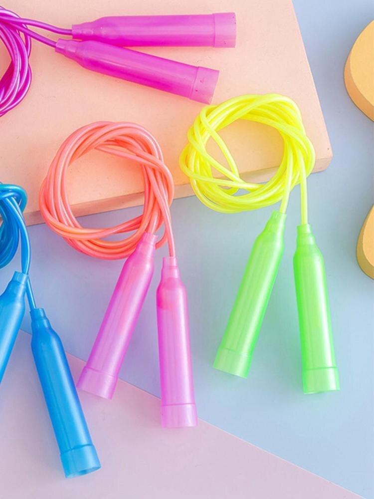 Colorful jump ropes on a pastel background