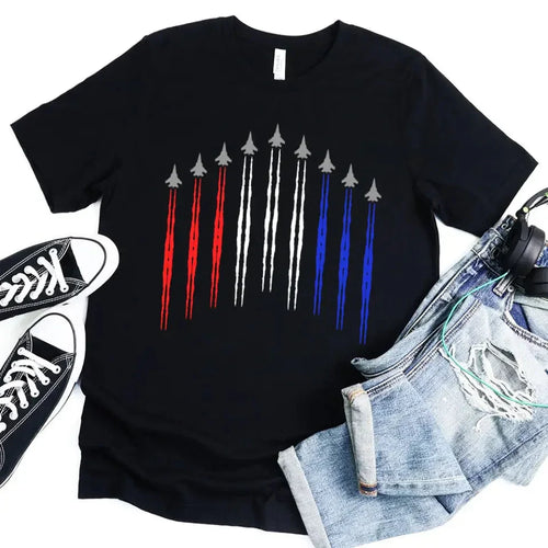 Black t-shirt with a graphic design of arrows in red, white, and blue, placed on a white background with sneakers and jeans.