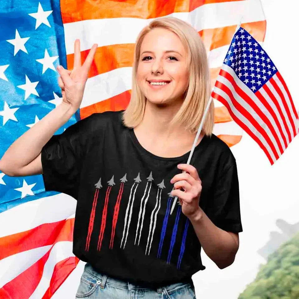Person wearing a black t-shirt with a flag design in front of an American flag