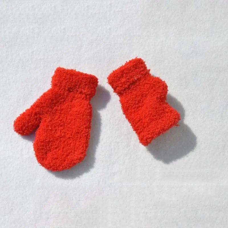 Pair of red fuzzy socks on a white background