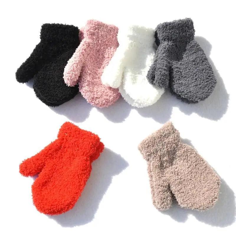 Set of colorful fluffy gloves on a white background