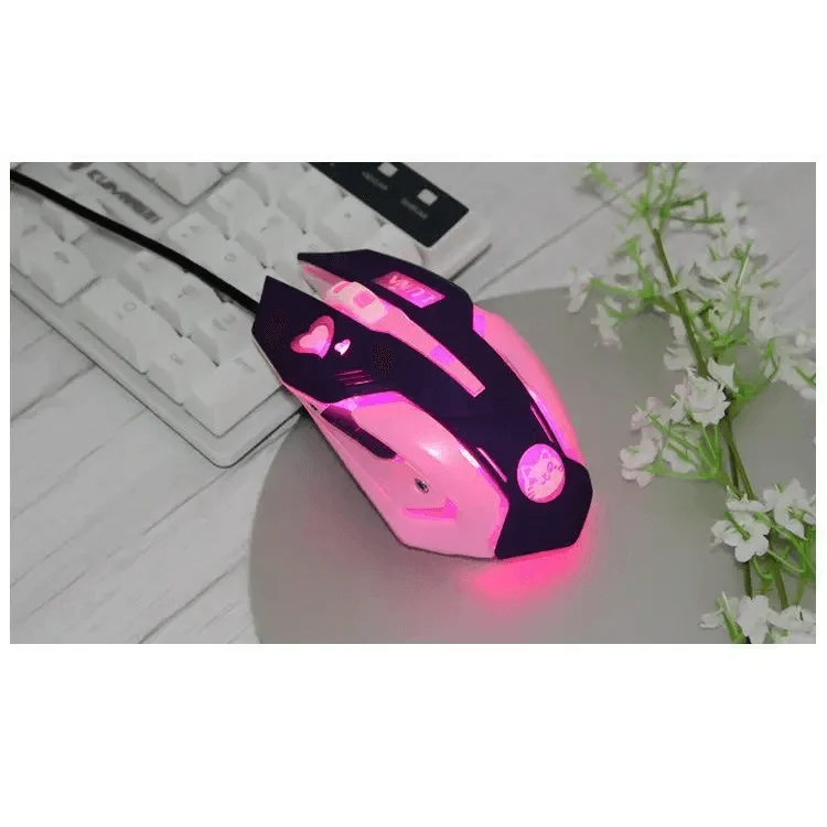 Pink and black gaming mouse on a desk with keyboard and flowers