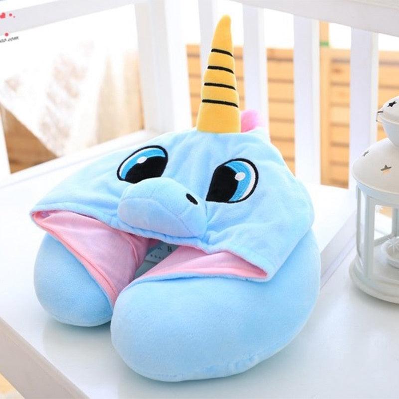 Blue plush unicorn toy with a yellow horn on a white surface.