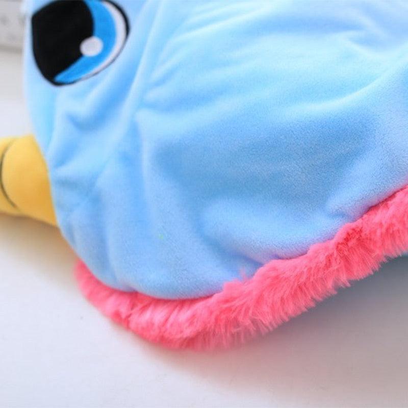 Close-up of a blue and pink plush toy with a white background