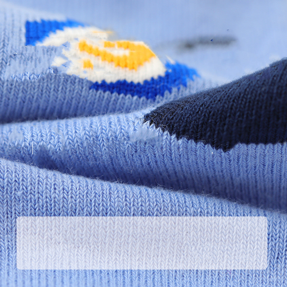 Close-up of blue fabric with a brand logo in the background