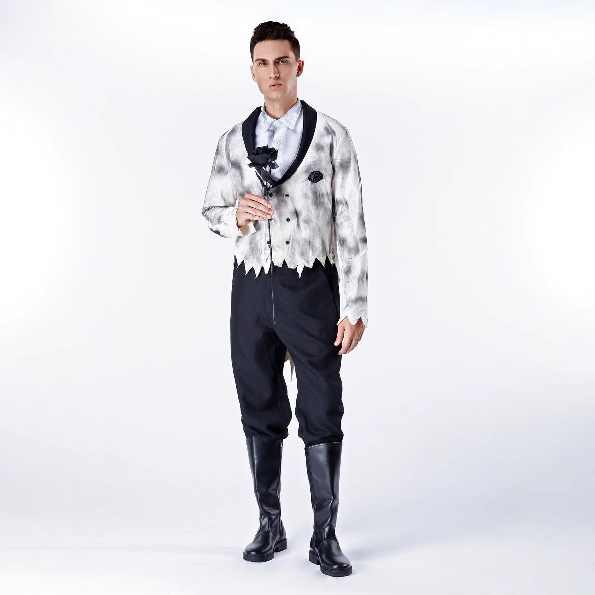Man wearing a unique outfit with a patterned shirt and black pants on a white background