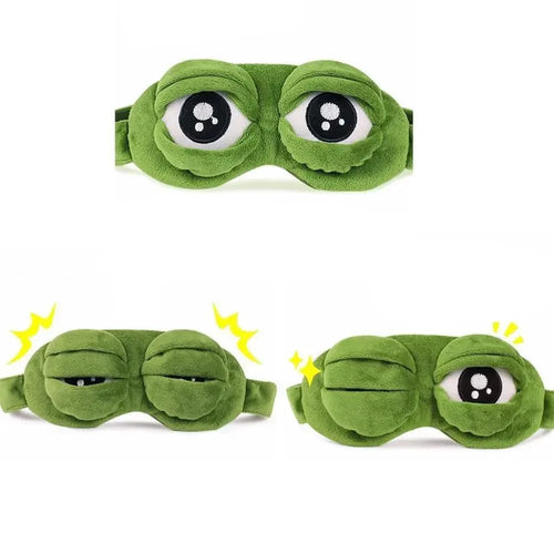 Green frog-themed eye mask with cartoonish eyes on a white background