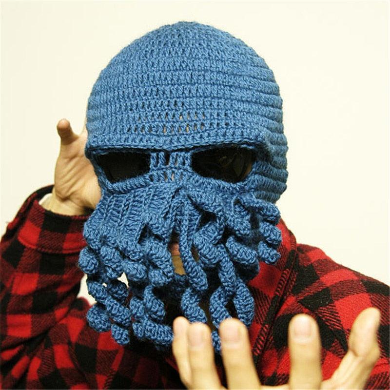 Person wearing a blue knitted cthulhu mask with a red plaid shirt.