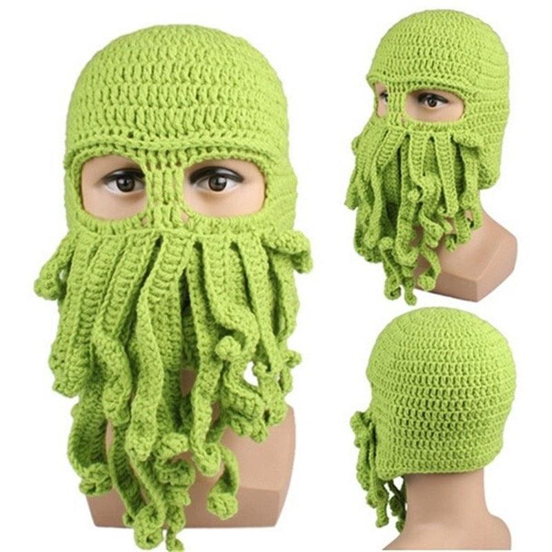 Green knitted octopus hat on a mannequin head with a plain background