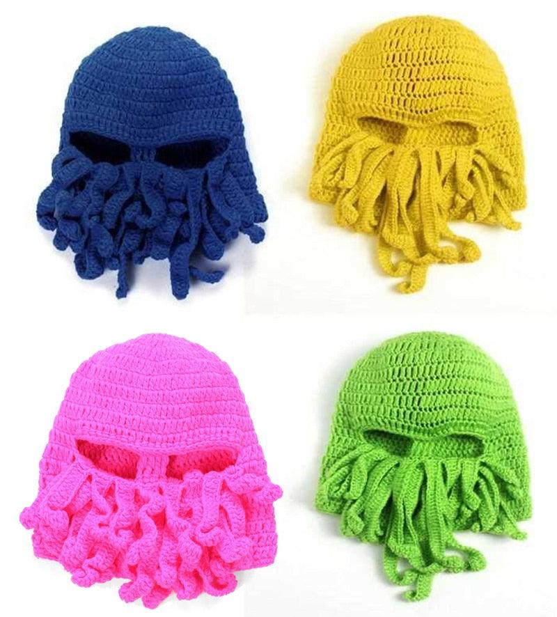 Four colorful knitted hats with face coverings in blue, yellow, pink, and green on a white background.
