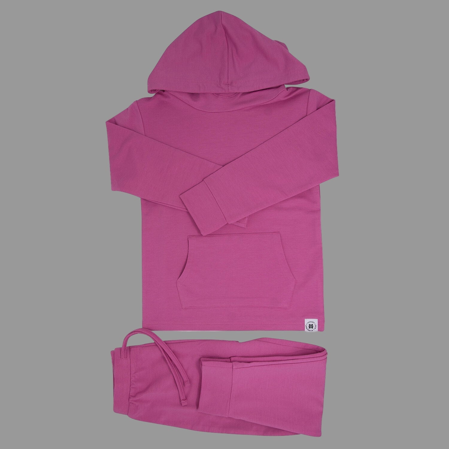 Pink hoodie with a small logo on a gray background