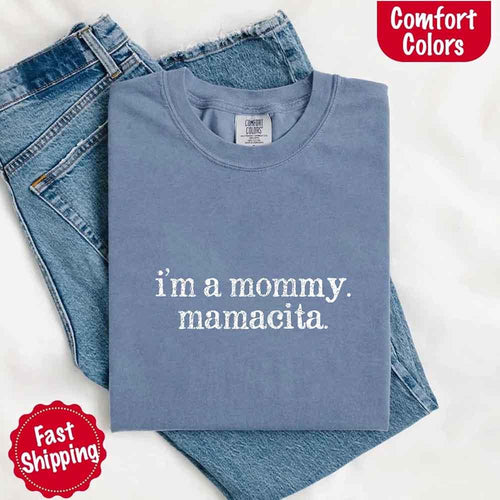 Blue t-shirt with 'i'm a mommy. mamacita.' text on jeans, with Comfort Colors logo.