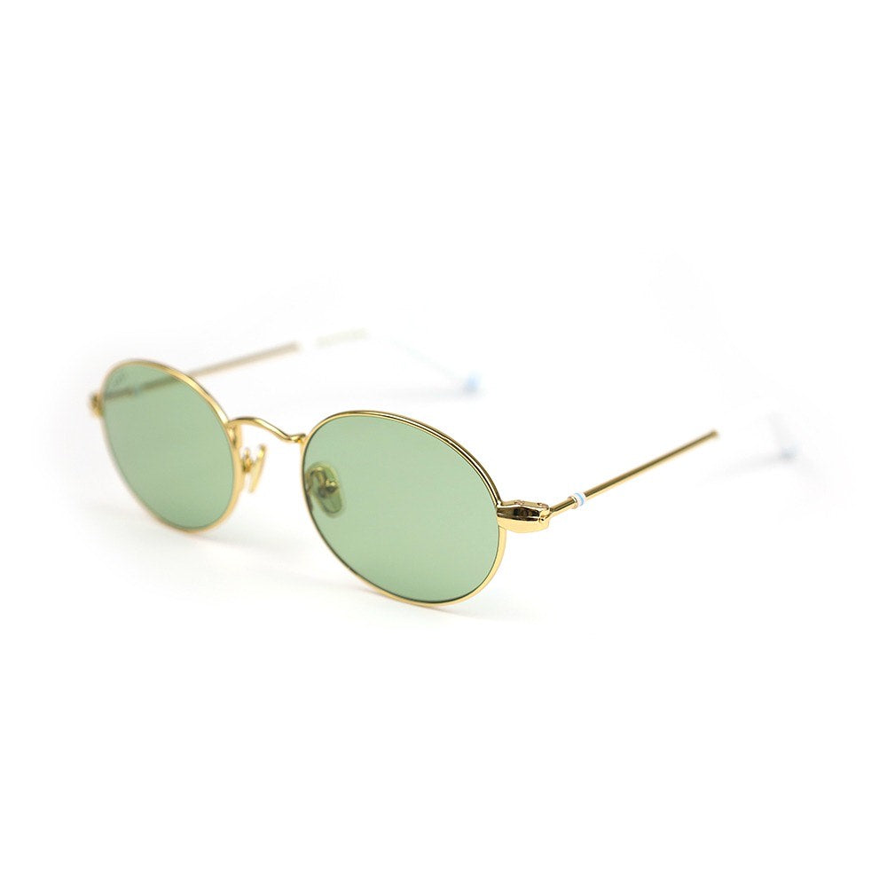 Gold-framed sunglasses with green lenses on a white background