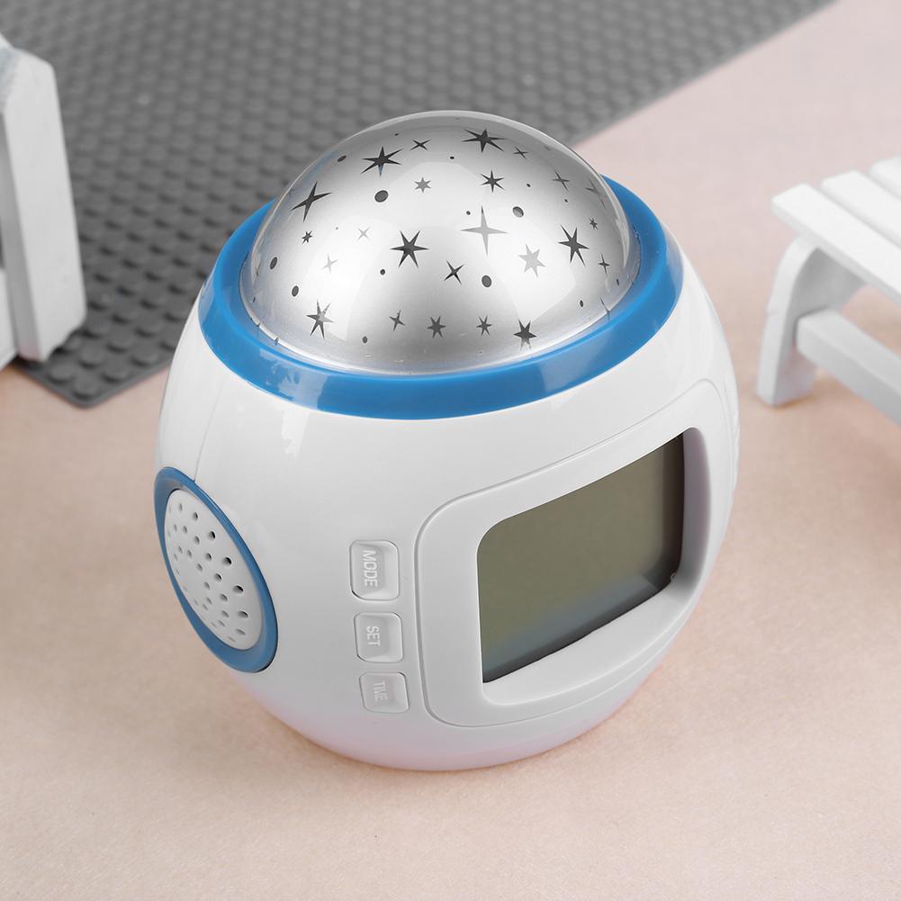 White and blue night light with star projector on a soft surface