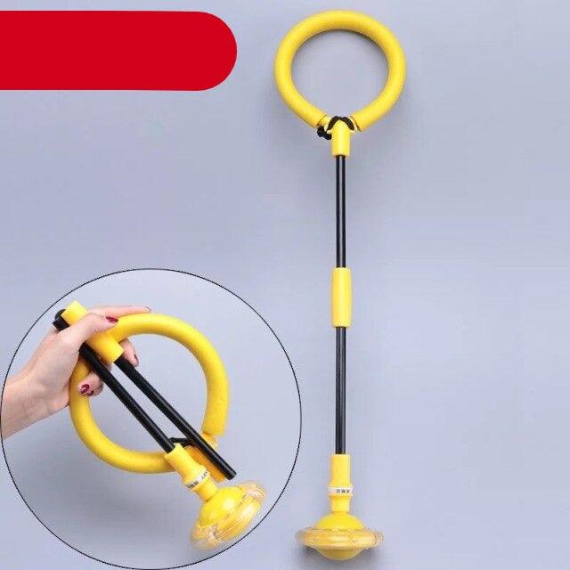 Yellow and black hoop with a hand holding it against a gray background