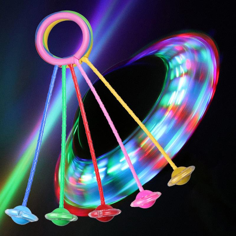 Colorful LED spinner toy with a heart-shaped light effect on a dark background