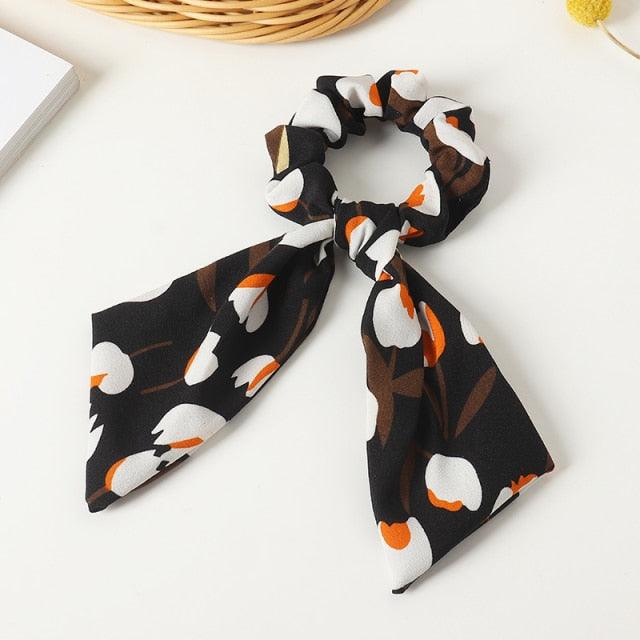 Black scrunchie with penguin pattern on a white background
