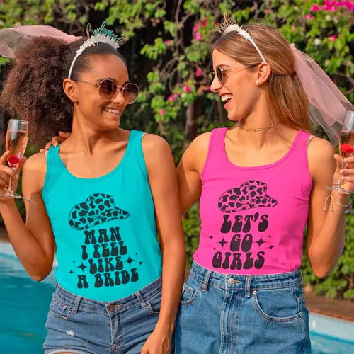 Two women wearing tank tops with bride-themed text by a poolside.