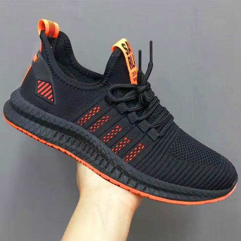 Black and orange sneaker on a gray background