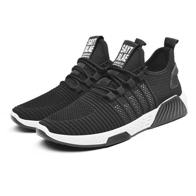 Black athletic shoes with white soles on a white background
