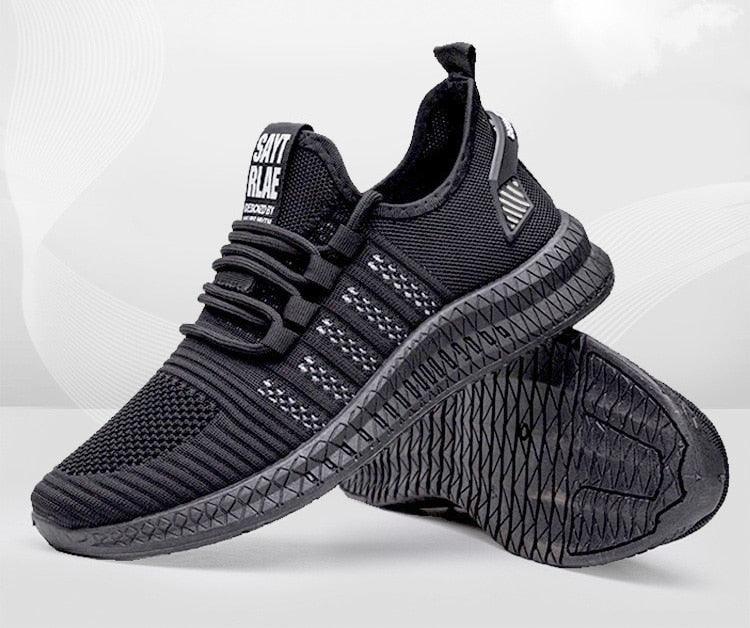 Black athletic shoes with textured sole on a white background