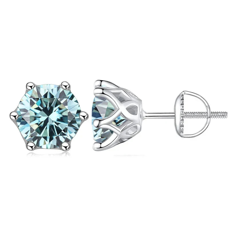 A pair of silver stud earrings featuring round-cut light blue gemstones in a prong setting, with one earring shown from the front and the other from the side/back view, on a white background.