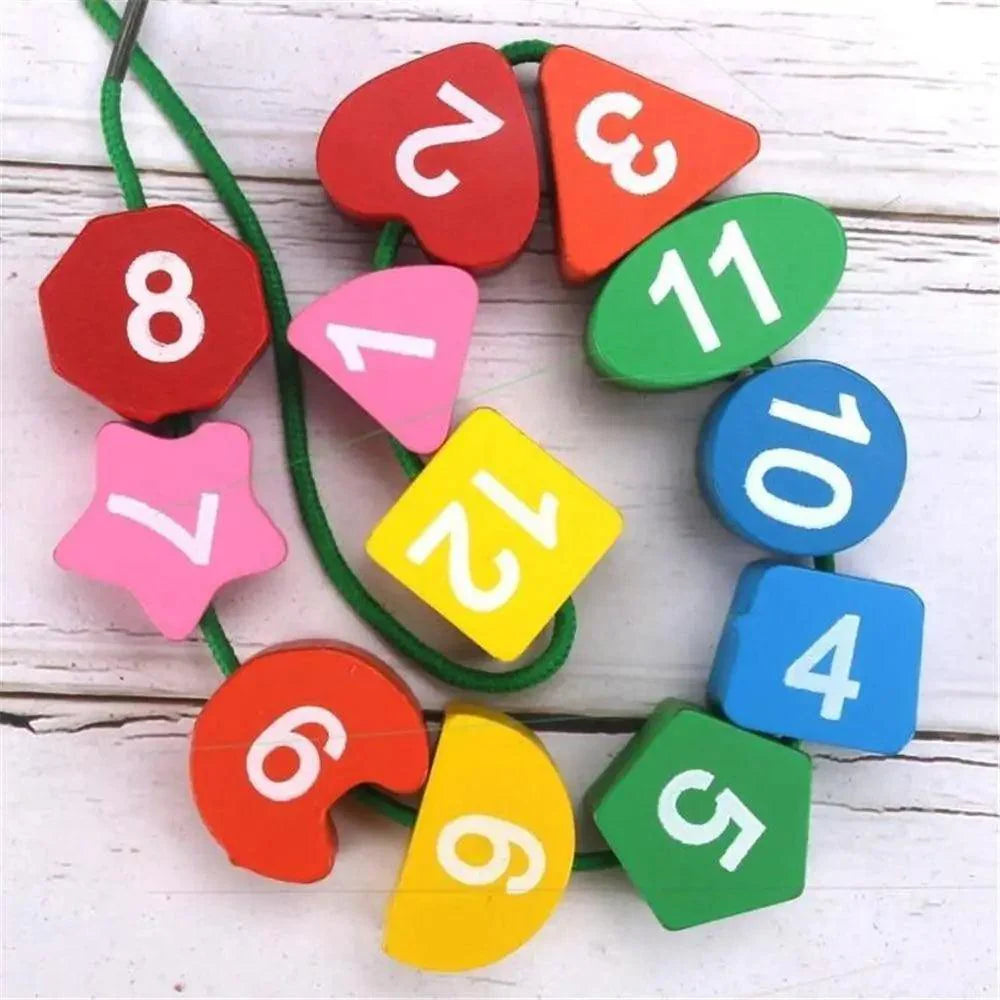 Colorful wooden numbers on a string against a white background