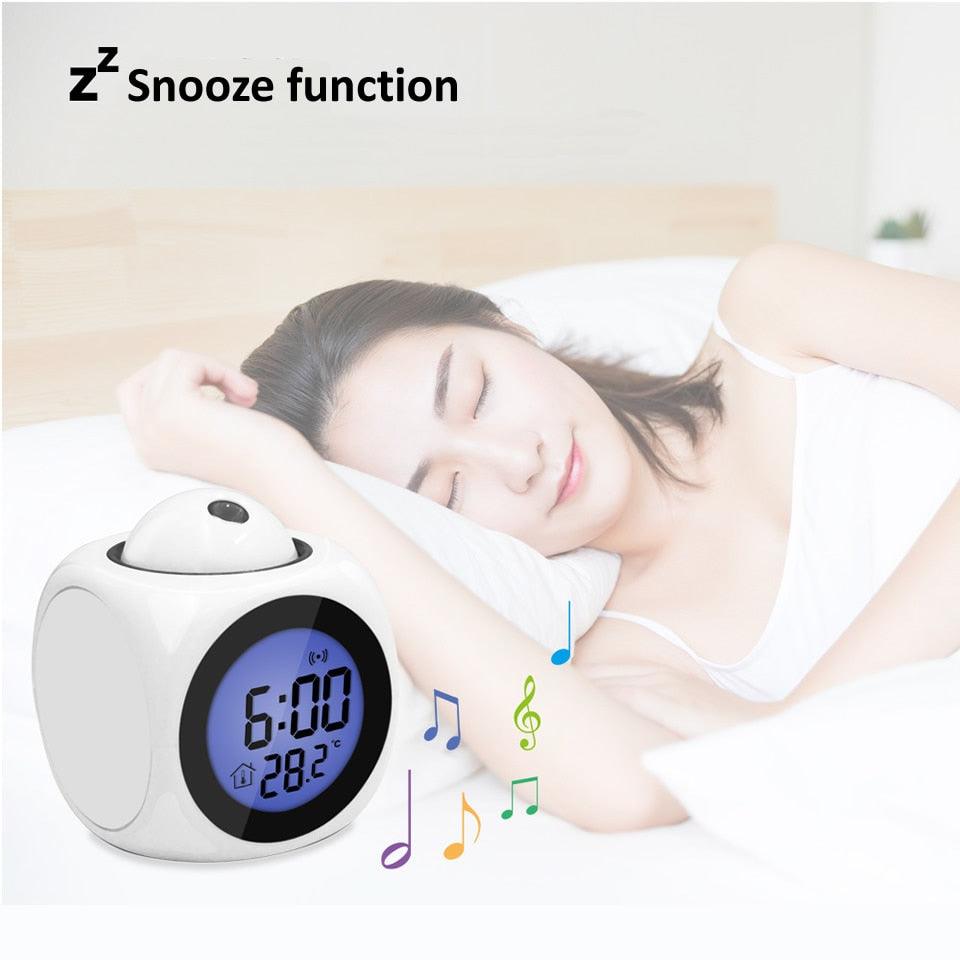 Alarm clock with snooze function displayed next to a person sleeping