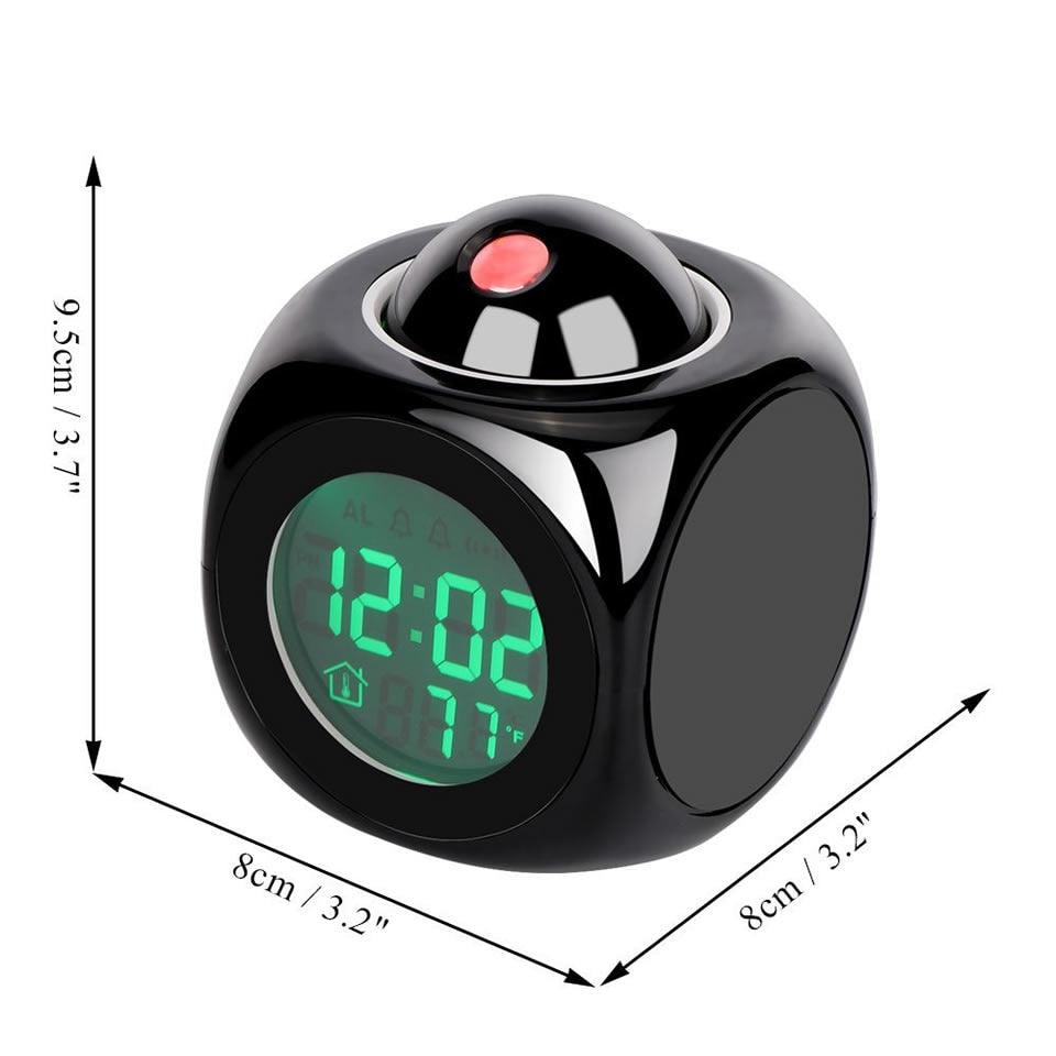 Black digital clock with green display and dimensions indicated