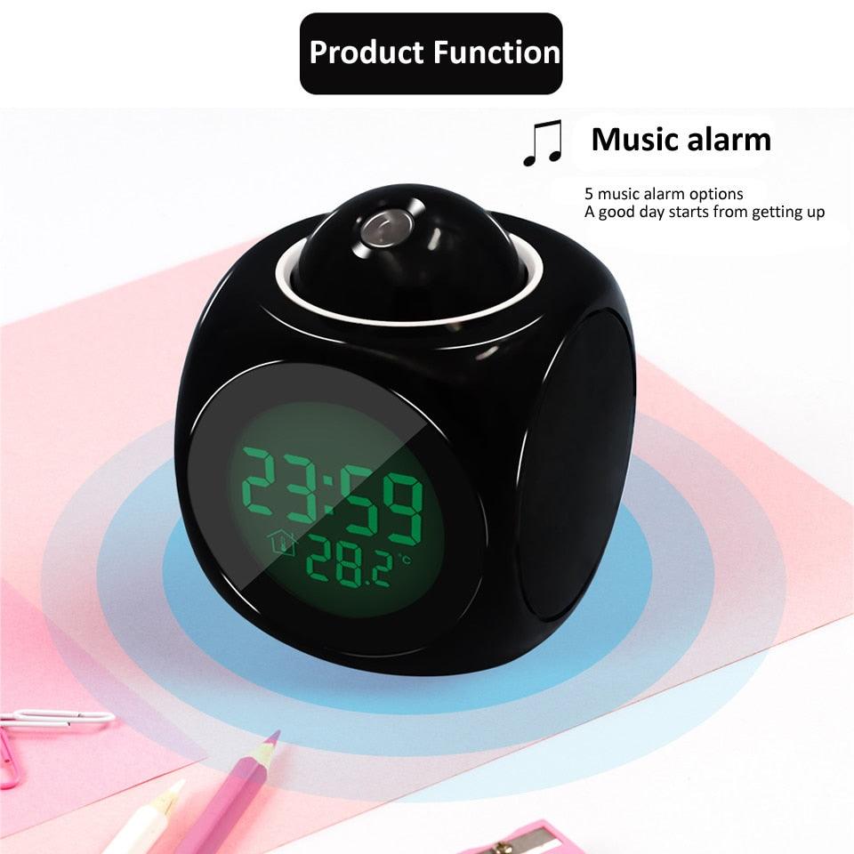 Black digital clock with music alarm feature on a light pink background