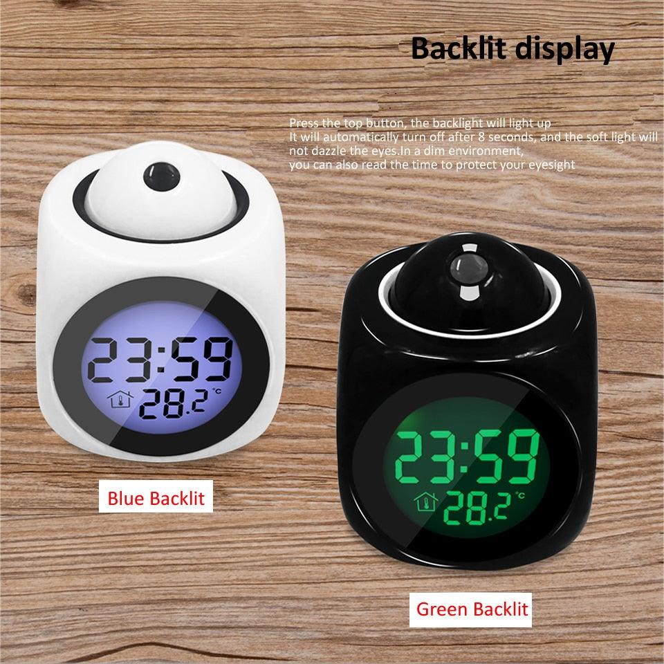 Two digital clocks with blue and green backlit displays on a wooden surface.
