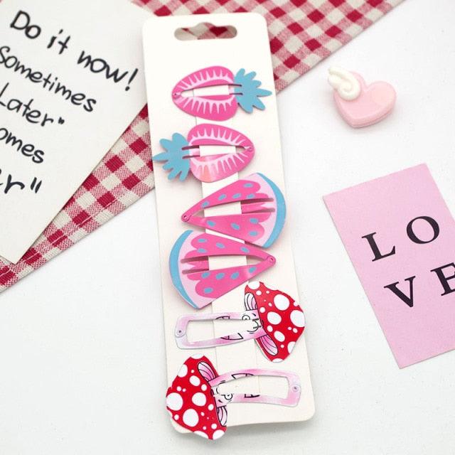 Set of colorful hair clips on a white card with a checkered fabric background