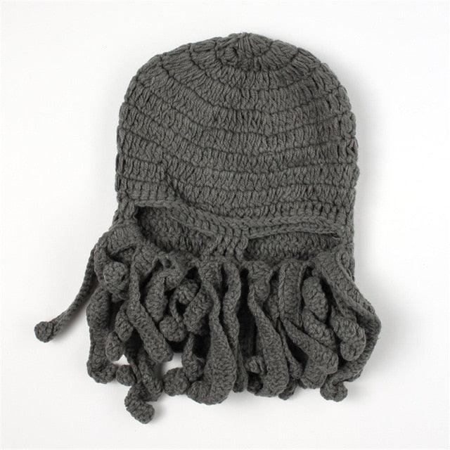 Gray knitted hat with fringe on a white background