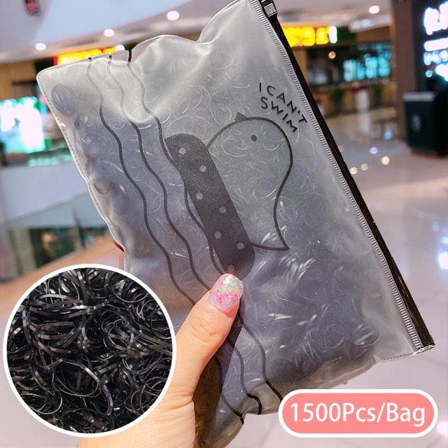 Clear bag with black strings, labeled 'Can't Swim', held by a hand in a mall setting.