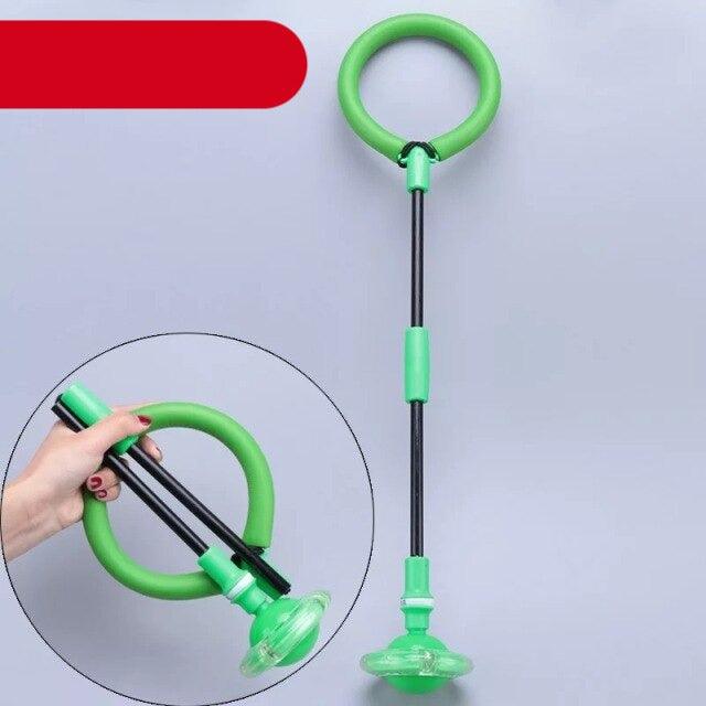 Green exercise device with handles on a gray background
