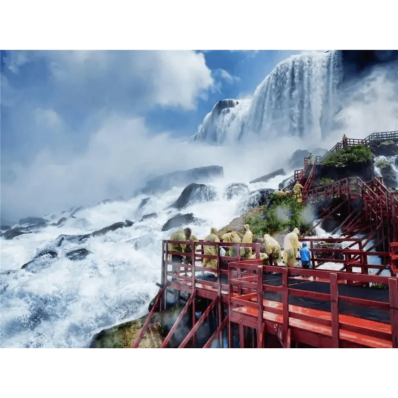 People on a red platform observing a large waterfall with misty clouds.