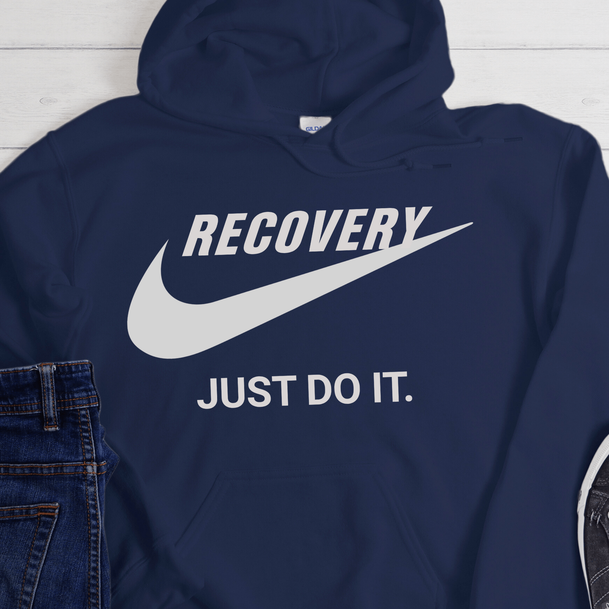 Navy blue hoodie with 'RECOVERY JUST DO IT.' text and Nike logo on a white background
