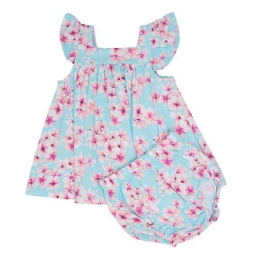 Floral baby romper with pink and blue flowers on a light blue background